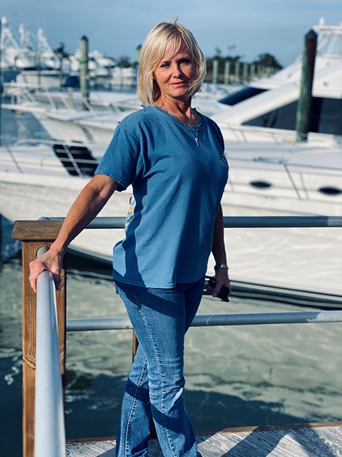 <b>Cathy DiMauro - Owner/Designer/Project Manager</b><br/>
During a career in the yachting industry that spans over 27 years, Crystal Coast Interiors Owner Cathy DiMauro has established a reputation for building solid relationships with her clients. Growing up with a passion and fascination for boats, she has worked and played hard in the waters of the Crystal Coast. After working for a local boat builder for a few years, Cathy began heading up a crew of 14 and was responsible for the interior and exterior wood finishing and finial detail on new construction. Later she went back to school to study interior design and realized with the shift from charter boat to sport fishing yachts, that the clientele needed a designer to help with their selections. With her attention to detail and knowledge of space planning, Cathy maintains the daily functionality of a boat while creating stunning custom interiors. 